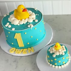 there is a cake with a rubber duck in the bathtub and one on top