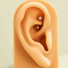 an ear is shown with a single diamond in it's middle and the other side