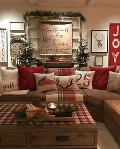 a living room filled with lots of furniture and christmas decorations on top of the couches