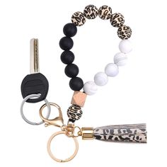 a key chain with a black, white and leopard print bead on it