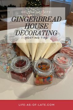 gingerbread house decorating with jars and candy in the foreground text reads holiday activity gingerbread house decorating hosting tips