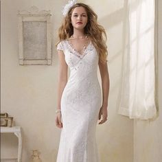 a woman in a white wedding dress posing for the camera