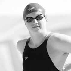 a woman in a swim suit and goggles