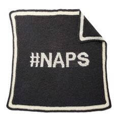 a knitted blanket with the word naps written on it, in white letters