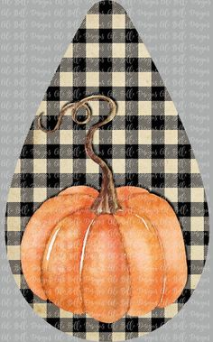 an orange pumpkin sitting on top of a checkered table cloth