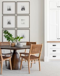 an image of a dining room setting with pictures on the wall and chairs around the table