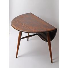 an oval wooden table with two legs and a curved design on the top, against a white background