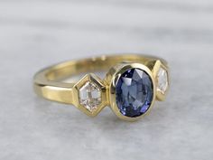 Luxury Handmade Gold Sapphire Ring, Modern Luxury Sapphire Ring, Luxury Gold Sapphire Ring In Modern Style, Luxury Gold Sapphire Ring With Recycled Gold, Elegant Luxury Gold Sapphire Ring, Timeless Luxury Yellow Gold Sapphire Ring, Modern Sapphire Ring With Rose Cut Diamonds, Modern Sapphire Ring With Diamond Center Stone, 18k Gold Engagement Ring