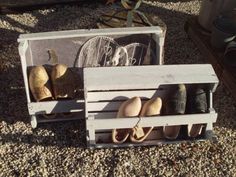 several pairs of shoes are sitting in a crate on the ground next to other items