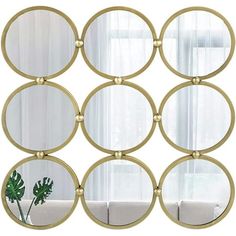 a set of six round mirrors sitting on top of a wall