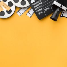 an overhead view of various movie equipment on a yellow background