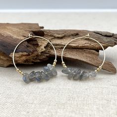 "These hoops are delicate, boho and unique! They feature small, genuine Labradorite gemstones floating freely on the hoop.  The hoops are about 1\" ( 25 mm ) large and the Labradorite stones are about 0.15\" - 0.3\" ( 4 - 8 mm ). They come in sterling silver or 14 K gold filled. Sold as a pair. A stone of transformation, Labradorite is a useful companion through change, imparting strength and perseverance. It balances and protects the aura, raises consciousness and grounds spiritual energies. Ex Bohemian Dangle Hoop Earrings With Natural Stones, Bohemian Hoop Earrings With Natural Stones, Small Hoop Earrings With Natural Stones For Everyday, Bohemian Hoop Earrings With Natural Stones For Jewelry Making, Bohemian Wire Wrapped Hoop Earrings For Everyday, Everyday Small Hoop Earrings With Natural Stones, Bohemian Small Hoop Earrings With Natural Stones, Bohemian Wire Wrapped Hoop Earrings, Bohemian Hoop Jewelry With Natural Stones