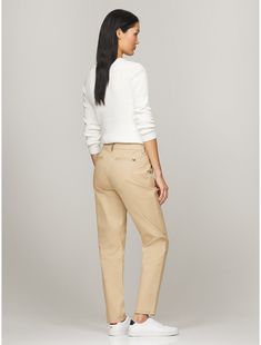 Tommy Hilfiger women's pant. Cut in a slim fit, our chino is made from a stretch-cotton blend offering lightweight breathability and comfort.  Material: 98% Better Cotton Initiative, 2% Elastane. Classic Slim Fit Mid-rise Chinos, Slim Fit Mid-rise Chinos For Work, Mid-rise Cotton Chinos For Work, Classic Mid-rise Cotton Chinos, Slim Fit Mid-rise Classic Chinos, Classic Mid-rise Chinos For Business Casual, Classic Tommy Hilfiger Tapered Leg Bottoms, Beige Straight Bottoms, Tommy Hilfiger Classic Tapered Leg Pants