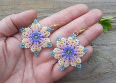 a pair of handmade beaded earrings in pastel colors