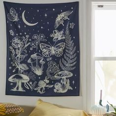 a tapestry hanging on the wall above a bed