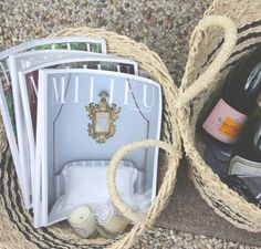 two baskets filled with bottles of wine sitting on the ground