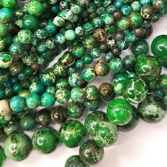 green and white marble beads are stacked on top of each other