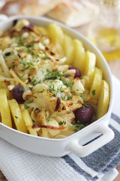 a casserole dish with potatoes and olives