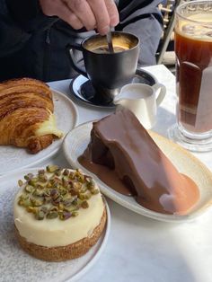 a table topped with plates filled with desserts and drinks