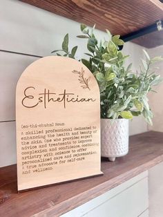 a wooden plaque that says, ethetian on it next to a potted plant