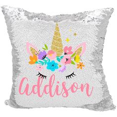 a silver sequin pillow with an unicorn's face and flowers on the front