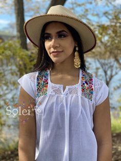 This Mexican Traditional Blouse has beautiful embroidered flowers that are hand embroidered with silk thread. The embroidery is San Antonino style. On the upper back it has a beautiful lace design. This blouse is perfect to look beautiful and comfortable. The blouse is made in Mexico by Artisan Hands made with love for you. This blouse comes one size which is ideal for sizes S,M and L. Peasant Floral Embroidered Top For Beach, Summer White Blouse With Tonal Embroidery, Fitted Floral Embroidered Top For Festival, Fitted Folk Style Embroidered Top, White Bohemian Tops With Tonal Embroidery, Summer Bohemian Blouse With Tonal Embroidery, Peasant Embroidered Top With Intricate Design For Summer, Peasant Style Embroidered Top For Summer, Peasant Embroidered Top For Summer