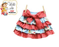 a red and white polka dot ruffled skirt on a clothes line with the words hello kitty