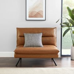 a living room with a couch and potted plant