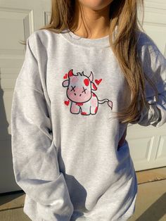 Look sweet and comfy in our Valentine Cow Crewneck Sweatshirt. This sweatshirt features long sleeves, a crew neckline, and beautiful front embroidery. The Unisex Sizing makes the sweatshirt run slightly larger than your average sweatshirt for women. Most men find their normal size to be more snug. If you want a slightly looser fit, size up one size. Please check out our size chart for measurements to ensure an accurate fit. PLEASE BE SURE TO INPUT YOUR CORRECT SIZE/COLOR + SHIPPING ADDRESS. We w Spring Crew Neck Streetwear Sweats, Cotton Long Sleeve Sweatshirt With Graphic Print, Spring Streetwear Sweats With Crew Neck, Spring Streetwear Crew Neck Sweats, Cute Long Sleeve Sweater For Streetwear, Spring Graphic Print Crew Neck Sweats, Cute Long Sleeve Fleece Tops, Gray Long Sleeve Sweater With Graphic Print, Cute Oversized Long Sleeve Sweatshirt