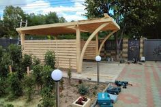 a wooden gazebo sitting in the middle of a yard