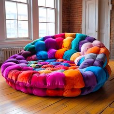 a multicolored bean bag chair sitting on top of a hard wood floor