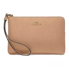 This Beautiful Coach Wristlet Is Perfect For Any Occasion. Crafted From High-Quality Leather, This Wristlet Features A Stylish Gold/Taupe Color With A Solid Pattern And Metal Accents. The Convenient Corner Zip Design Provides Easy Access To Your Credit Cards And Other Essentials While On The Go. With Its Compact Size And Versatile Style, This Wristlet Is A Must-Have Accessory For Any Fashion-Forward Woman. Whether You're Running Errands Or Hitting The Town With Friends, This Coach Wristlet Adds Classic Bags With Wrist Strap For Daily Use, Coach Beige Pouch Wristlet, Beige Coach Pouch Wristlet, Beige Rectangular Wristlet For Travel, Classic Everyday Bag With Wrist Strap, Classic Everyday Bags With Wrist Strap, Coach Beige Wristlet With Removable Pouch, Coach Beige Wallet With Wrist Strap, Coach Beige Wallets With Wrist Strap