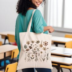 🌿 Embrace nature's charm with our Canvas Tote Bag, featuring an exquisite wildflower design. Unique wildflowers rendered in beautiful earthy tones.  🌸 This tote is not just a bag; it's a piece of art, perfect for adding a touch of boho elegance to your everyday style. 👜 Made from 100% cotton, this durable tote measures 15''x16'', offering ample space for your essentials. Whether you're heading to the farmer's market, a day out with friends, or packing for a quick getaway, this bag is your go-to choice for both style and practicality. 💐 Ideal for bridal parties and bachelorette events, it adds a personalized and thoughtful touch. Surprise your bridesmaids with this unique gift that they can use long after your special day. It's not just a bag; it's a keepsake. 🎁 Perfect for any woman w Green Nature-inspired Bag For Everyday Use, Nature-inspired Green Bags For Everyday Use, Nature-inspired Rectangular Bag For Daily Use, Everyday Nature-inspired Rectangular Bag, Nature-inspired Everyday Rectangular Bag, White Botanical Bag For Daily Use, White Botanical Bags For Daily Use, Botanical Style Gift Bag For Everyday Use, Botanical Style Everyday Use Gift Bag