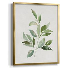 a painting with green leaves hanging on a wall above a framed canvas, it is white and has gold trim around the edges