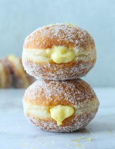 two powdered donuts with butter on them