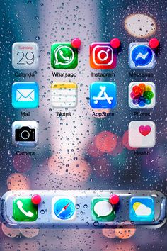 an iphone with icons on the screen and raindrops all over it's surface