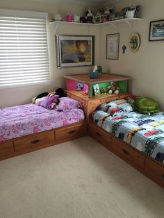 two twin beds in a bedroom next to each other with stuffed animals on the covers