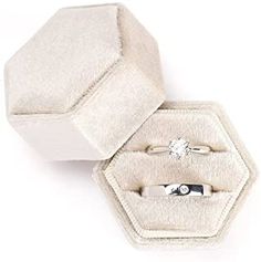 an open ring box with two rings in it