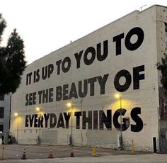 an advertisement on the side of a building that says it is up to you to see the beauty of everyday things