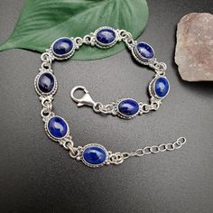 "Visit our on-line shop at: Etsy.com/shop/AlbuquerqueDesigns *sterling silver bracelet 7.25 inches long / 8 links with extension 1\" silver chain *link bracelet *southwestern jewelry *lapis lazuli *calibrated pre-cut stones: 9x7mm oval shape *back of jewelry items are all covered / do not show the back of stones *all jewelry items are made to ship, slight variations in stones will occur comparing to pictures. *size of a penny is 19mm or a dime is 18mm in diameter for comparing size with jewelry Blue Natural Stones Sterling Silver Bracelets, Blue Oval Sterling Silver Bracelet Gift, Oval Blue Sterling Silver Bracelet As Gift, Oval Blue Sterling Silver Bracelet Gift, Adjustable Blue Oval Sterling Silver Bracelet, Adjustable Oval Blue Sterling Silver Bracelet, Adjustable Oval Sterling Silver Bracelet In Blue, Adjustable Blue Oval Jewelry, Oval Sterling Silver Bracelet With Natural Stones