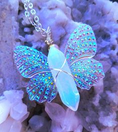 You'll receive a gorgeous Butterfly Necklace, Wire Wrapped Opalite Crystal Pendant, Sugar Plum Fairy Glow in the Dark Wings, Dainty Fairycore Gift for Jewelry Lovers.  >> GIFT WRAP AVAILABLE FOR $3.00 DURING CHECKOUT << Introducing our exquisite Crystal Butterfly Necklace that we call the "Sugar Plum Fairy" because of her magical light, glitter & sparkle. A truly enchanting piece that combines the timeless beauty of crystal with the whimsy of a butterfly, all with a mesmerizing glowing twist. Th Fairy Themed Jewelry Crystal, Opalite Crystal Necklace, Dark Wings, Opalite Crystal, Sugar Plum Fairy, Aura Crystals, Fairy Necklace, Butterfly Fairy, Wire Wrapping Crystals