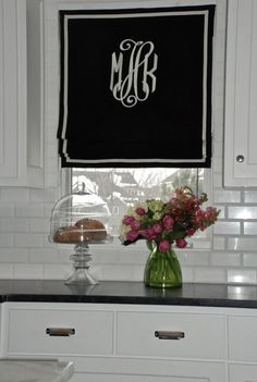 a vase with flowers on a kitchen counter