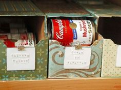 two boxes filled with cans and labels on top of a shelf