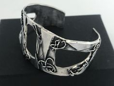 "Artisan Hand Made Sterling Silver Brutalist Cutout Cuff. Unique mix of polished and oxidized sterling silver accented with geometric and free form patterns. Lightly cleaned ready to wear. Will Fit Wrists Up To 6 3/4\" Markings: Unmarked, Acid tested and sterling silver. Measurements: Approx 6 3/4 inch total inside circumference including wrist opening, 2 3/8 inch inside diameter, 1 1/8 inch wrist opening and 1 3/4\" wide at front center. Total Weight: 40.5 grams Condition: Good Vintage Conditio Artistic Silver Cuff Bracelet, Modern Oxidized Finish Cuff Bracelet As A Gift, Modern Cuff Bracelet With Oxidized Finish As Gift, Modern Oxidized Finish Cuff Bracelet, Artistic Silver Cuff Bracelet Bangle, Artistic Silver Cuff Bangle Bracelet, Artistic Silver Bangle Cuff Bracelet, Handmade Contemporary Bangle Cuff Bracelet, Modern Silver Cuff Bracelet With Oxidized Finish