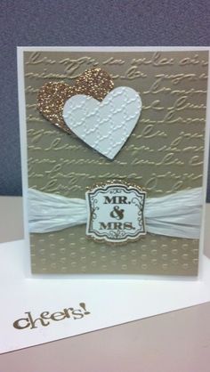 a card with two hearts on it and the words mr and mrs written in gold