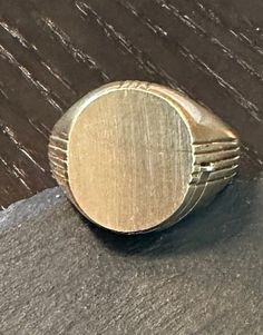 A Rare 10K gold not monogramed signet ring with a hidden locket.  Condition as photos show in great condition, sliding hidden locket works perfectly.  Size 10, wt.- 7.8 grams.  Great classic modernist design and with the hidden locket-a very rare find and in such great condition-a great ring to wear and what a conversation piece. Modernist Oval Signet Ring For Gift, Modernist Polished Signet Ring, Luxury Hallmarked Brass Signet Ring, Antique Gold-colored Sterling Silver Signet Ring, Gold Coin-shaped Signet Ring For Gift, Envelope Stamp, Gold Signet Ring, Lovely Ring, 10k Gold