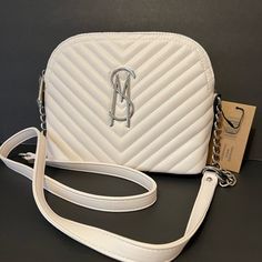 Brand New With Tag Hard To Find Steve Madden Crossbody Dom Bag Quilted Faux Leather White Color Silver Hardware Sm Logo Plate On The Front Crossbody Strap With Chain Zipper Closure On The Top Lined Interior: One Zip & One Slip Pocket Approximately 9"Lx7"Hx3.5"W Very Elegant Classy Purse New To My Collection Please See My Entire Collection White Evening Bag With Zipper Closure, White Shoulder Bag With Zipper Closure For Evening, Sm Logo, Classy Purses, Yellow Purses, Steve Madden Purse, Mini Crossbody Purse, Blue Purse, Round Bag