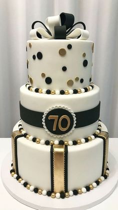 a white cake with black and gold decorations