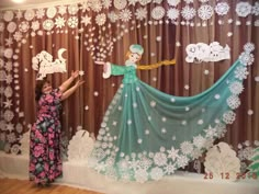 the curtain is decorated with snowflakes and an image of a woman in a green dress