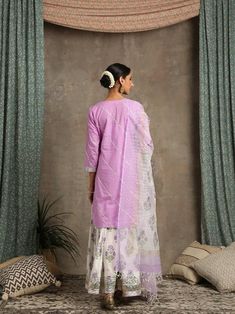 Set of 3 consists of kurta, dupatta and sharara. Kurta- U shape cotton kurta with lehriya gota work and bijiya detailing. Sharara- coton ghera sharara with hand printed poppies in soothing lavender. Detailed with lappa and handmade magzi at the ghera and joint of the sharara. Dupatta- Hand woven kota doriya dupatta. Colour - Ivory / Lavender Fabric - Cotton / Kota Doria Occasion - Festive Wear / Occasion Wear Fit - straight and flowy Pattern - Solid Care - Dry Clean only Estimated Delivery 15-20